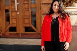 hübsches latino-modellmädchen aus ecuador wear auf schwarzer und roter jacke posierte auf der straße. foto