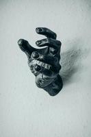 Skulptur einer Hand auf Schnee, die nach oben greift foto