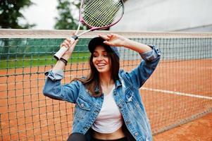 junge sportliche Spielerin mit Tennisschläger auf dem Tennisplatz. foto