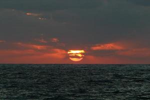 die sonne geht unter dem horizont am mittelmeer im norden israels unter. foto