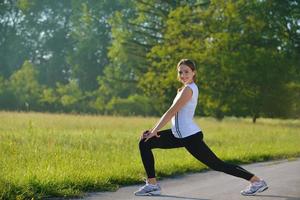 junge schöne Frau, die morgens im Park joggt foto