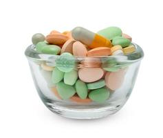 Pille in Glasbecher isoliert auf weißem Hintergrund, enthalten Beschneidungspfad foto