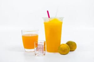 Slush-Eis mit Orange im weißen Hintergrund des Plastikbechers. foto