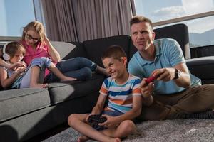 glückliche familie, die ein videospiel spielt foto