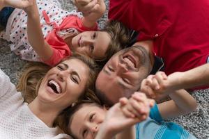 glückliche familie, die auf dem boden liegt foto