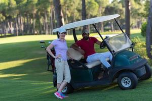 Paar im Buggy auf dem Golfplatz foto