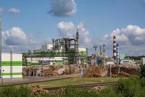 Rohre des Sägewerks des Holzbearbeitungsunternehmens in der Nähe des Flusses. Luftverschmutzungskonzept. Industrielandschaft Umweltverschmutzung Abfall von Wärmekraftwerken foto