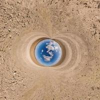 Ball des blauen Himmels mitten in der wirbelnden Sandstraße. Umkehrung der winzigen Planetentransformation des sphärischen Panoramas 360 Grad. Krümmung des Raumes. foto