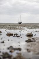 Fischerboote stecken bei Ebbe am Strand fest. foto