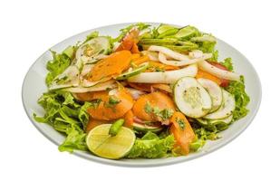 Gurkensalat auf dem Teller und weißem Hintergrund foto