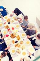 Draufsicht der modernen multiethnischen muslimischen Familie, die auf den Beginn des Iftar-Abendessens wartet foto