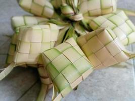 ketupat ist in indonesien eine art, reis zu kochen, indem reis in ein kokosnussblatt gesteckt wird, das wie ein diamant geformt ist. dann gedämpft. sehr berühmt in indonesien. erscheint normalerweise auf eid al-fitr foto