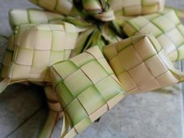 ketupat ist in indonesien eine art, reis zu kochen, indem reis in ein kokosnussblatt gesteckt wird, das wie ein diamant geformt ist. dann gedämpft. sehr berühmt in indonesien. erscheint normalerweise auf eid al-fitr foto