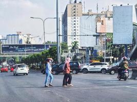 Zwei muslimische Frauen mit Kopftüchern überqueren die Straße nicht an der richtigen Stelle. foto