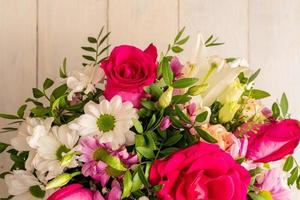 Gemischter Blumenstrauß aus verschiedenen Blumen auf Holzhintergrund, Ansicht von oben foto