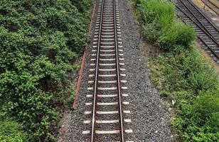 Mehrere Bahngleise mit Abzweigungen an einem Bahnhof perspektivisch und aus der Vogelperspektive foto