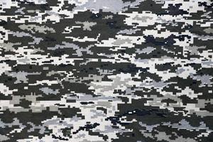 Stoff mit Textur der ukrainischen Militär-Pixeltarnung. Stoff mit Tarnmuster in grauen, braunen und grünen Pixelformen. offizielle uniform der ukrainischen soldaten foto