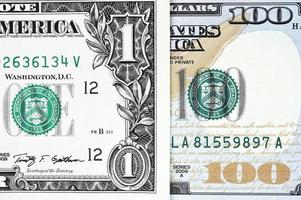 Makroaufnahme eines neuen 100-Dollar-Scheines und eines Dollars foto