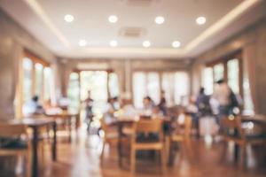 restaurantinnenraum mit kunden- und holztisch verwischen abstrakten hintergrund mit bokeh-licht foto