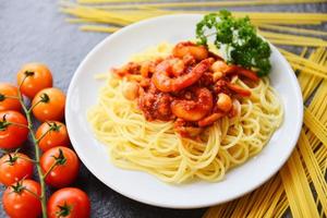 Spaghetti Bolognese italienische Pasta mit Garnelen Garnelen serviert auf weißem Teller mit Tomaten-Petersilie im Restaurant italienische Küche und Menü foto