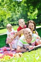 glückliches junges Paar mit ihren Kindern haben Spaß im Park foto