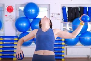 .glückliche junge Frau, die in einem Fitnessstudio trainiert foto