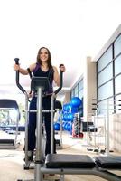 Frauen, die im Fitnessstudio auf Spinning-Rädern trainieren foto