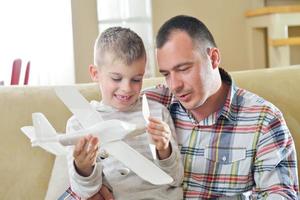 Vater und Sohn bauen Flugzeugspielzeug zusammen foto