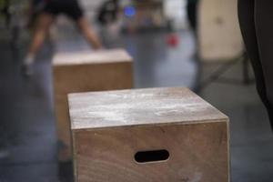 Schwarze Frau führt Boxsprünge im Fitnessstudio durch foto