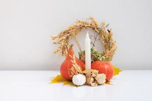 Herbstkomposition. getrocknete Blätter, Kürbisse und Kerzen auf weißem Hintergrund. herbst herbst und erntedankfest konzept. Stillleben foto