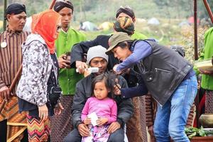 dieng, indonesien - 1. august 2015. dieng-kulturfestival, touristen folgen der dreadlocks-prozession während der dieng-kulturfestivalveranstaltung in dieng, banjarnegara-bezirk, zentrales java foto