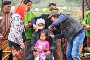 dieng, indonesien - 1. august 2015. dieng-kulturfestival, touristen folgen der dreadlocks-prozession während der dieng-kulturfestivalveranstaltung in dieng, banjarnegara-bezirk, zentrales java foto