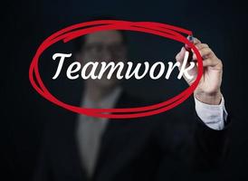 Geschäftsmann Hand schreiben Teamwork mit roter Markierung auf transparentem Brett, neues Geschäftskonzept, Studioaufnahme foto