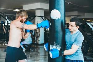 Boxer mit Boxsack im Fitnessstudio foto