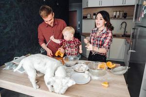 Hund auf dem Küchentisch. glückliche Familie in der Küche foto