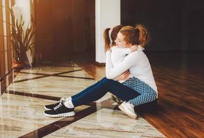 mutter und tochter umarmen sich im fitnessstudio foto