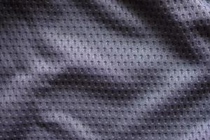 graues Sportbekleidungs-Fußballtrikot aus Stoff mit Air-Mesh-Texturhintergrund foto