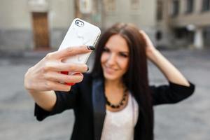 schönes Mädchen macht sich in der Stadt foto