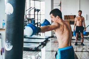 Boxer mit Boxsack im Fitnessstudio foto