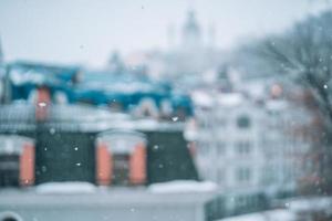 reichlicher Schneefall über der Stadt mit den Dächern foto