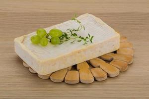Brie-Käse auf Holzbrett und Holzhintergrund foto