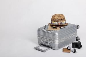 reisegepäck mit pass, kamera, hut, brieftasche, flugzeugspielzeug isoliert auf weißem hintergrund mit kopienraum, reisekonzepthintergrund foto
