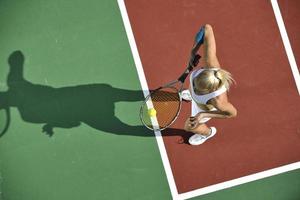 junge Frau spielt Tennis im Freien foto