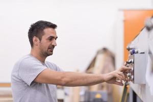 Arbeiter in einer Holzmöbelfabrik foto