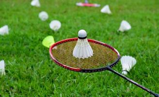 Badmintonschläger und Badmintonfederball vor bewölktem und blauem Hintergrund, Badmintonspielkonzept im Freien. selektiver Fokus auf Schläger. foto