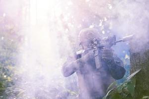 Soldat in Aktion, der auf Laservisieroptik zielt foto