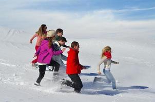 freunde haben spaß im winter auf frischem schnee foto