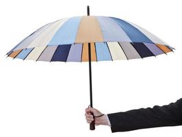 Männerhand mit offenem gestreiftem Regenschirm foto