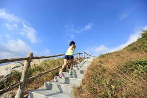junge Fitnessfrau Trailrunner läuft auf Bergtreppe