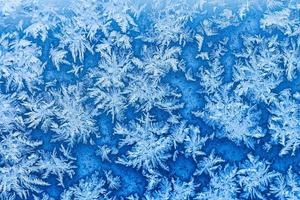 Schneeflocken und Frost am Fenster im Winter aus nächster Nähe foto